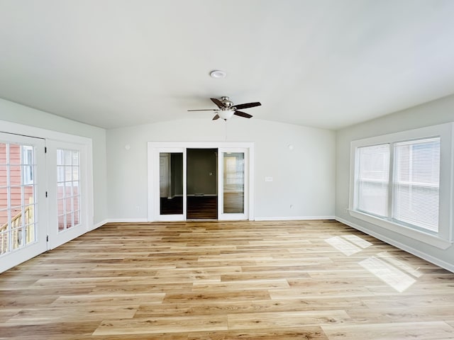 unfurnished room with light wood-type flooring, lofted ceiling, baseboards, and a ceiling fan