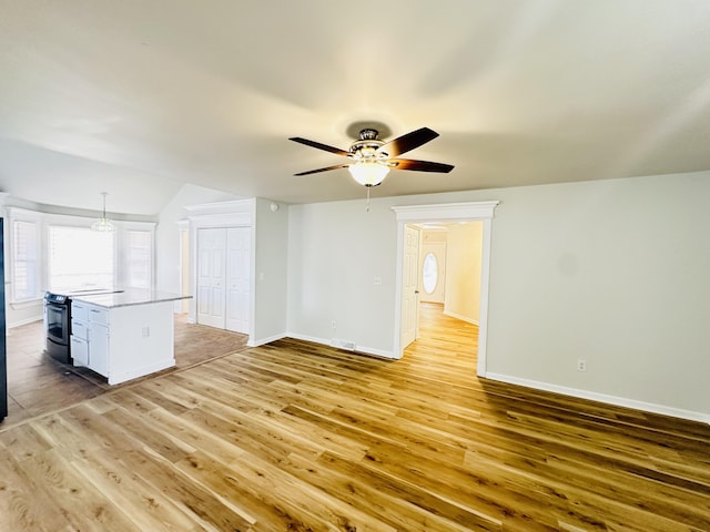 unfurnished living room with visible vents, baseboards, light wood-style floors, and ceiling fan