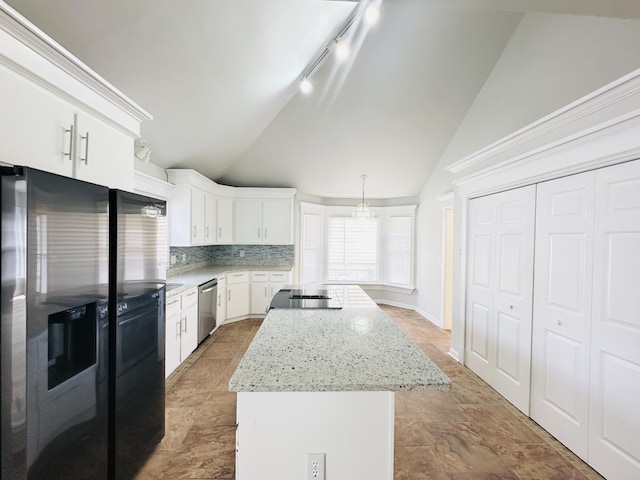 kitchen featuring a kitchen island, lofted ceiling, decorative backsplash, appliances with stainless steel finishes, and white cabinets