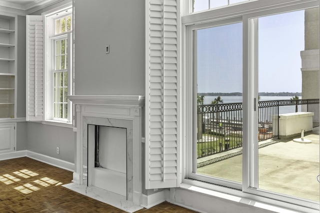1 King Street 209 & 210, Charleston, SC 29401 - unfurnished living room with a water view, a premium fireplace, and crown molding