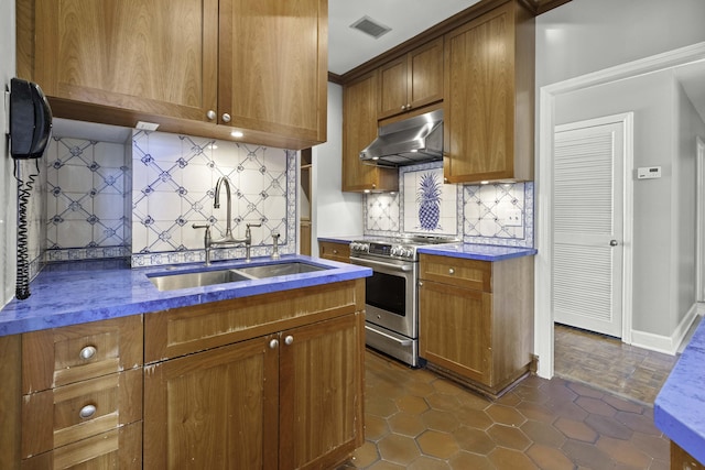 1 King Street 209 & 210, Charleston, SC 29401 - kitchen featuring stainless steel range oven, under cabinet range hood, and brown cabinetry