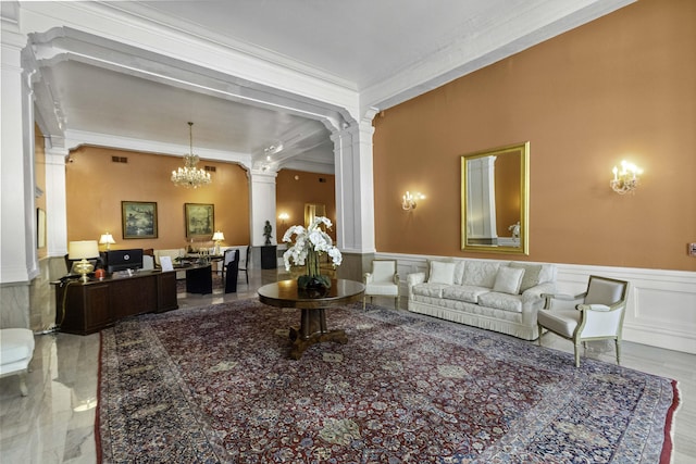 1 King Street 209 & 210, Charleston, SC 29401 - living area with crown molding, wainscoting, a chandelier, a decorative wall, and decorative columns
