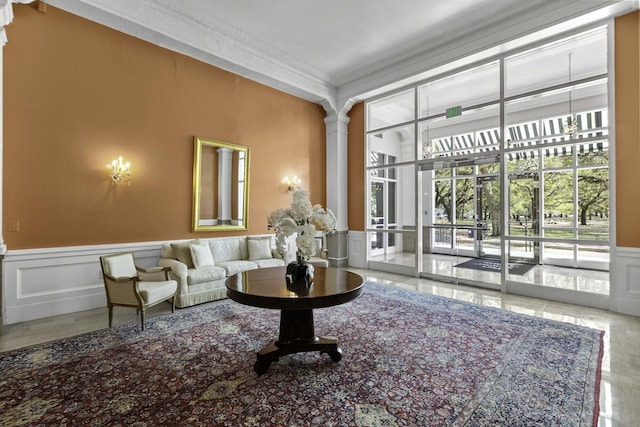1 King Street 209 & 210, Charleston, SC 29401 - living area featuring crown molding, a decorative wall, and a wainscoted wall