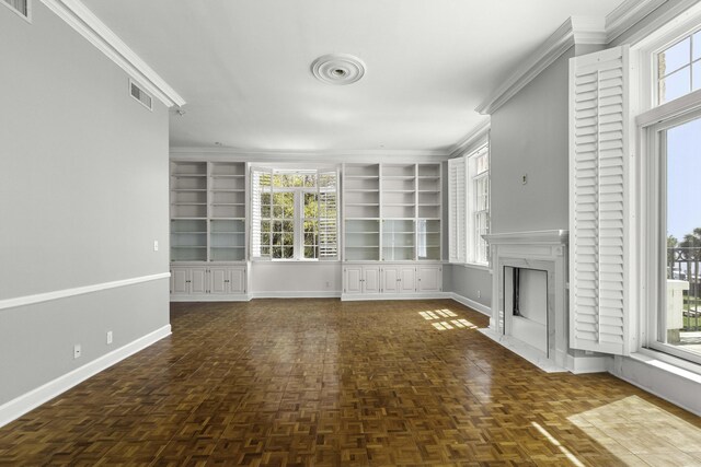 1 King Street 209 & 210, Charleston, SC 29401 - unfurnished living room featuring built in shelves, a fireplace, and crown molding