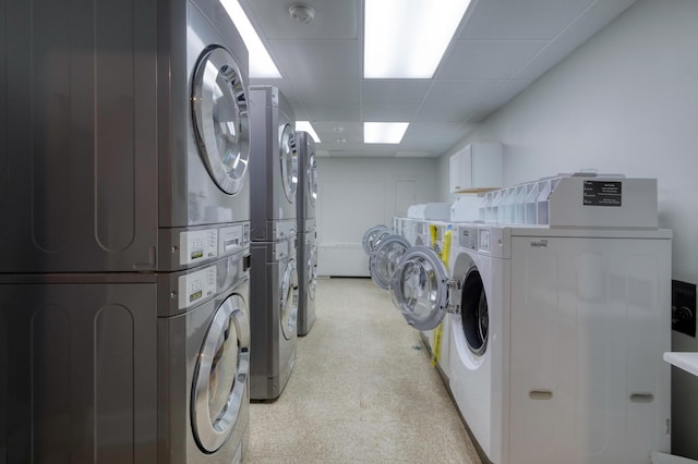 1 King Street 209 & 210, Charleston, SC 29401 - communal laundry room with stacked washing machine and dryer, washing machine and dryer, and light flooring