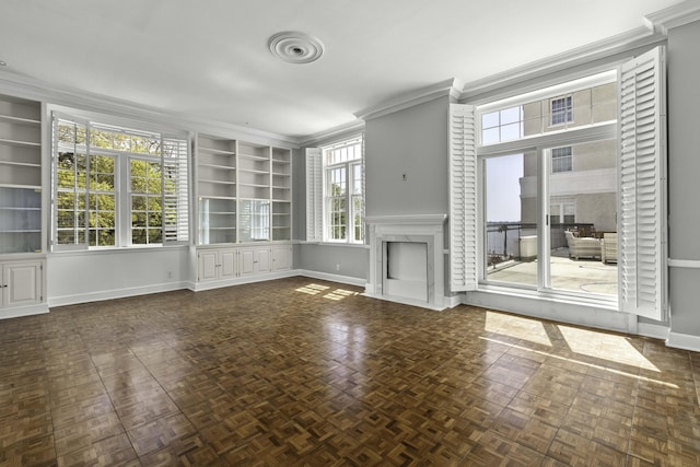 1 King Street 209 & 210, Charleston, SC 29401 - unfurnished living room featuring built in features, a fireplace with flush hearth, and crown molding