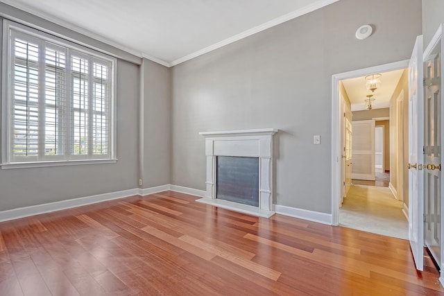 1 King Street 209 & 210, Charleston, SC 29401 - unfurnished living room featuring wood finished floors, plenty of natural light, crown molding, and a fireplace