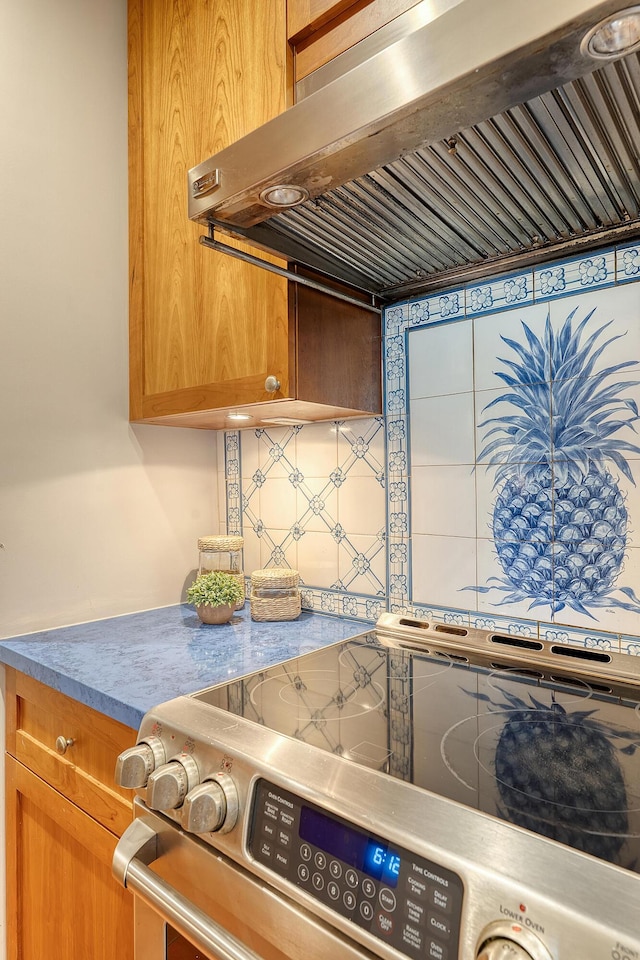 1 King Street 209 & 210, Charleston, SC 29401 - kitchen featuring stainless steel electric range, range hood, backsplash, and brown cabinetry