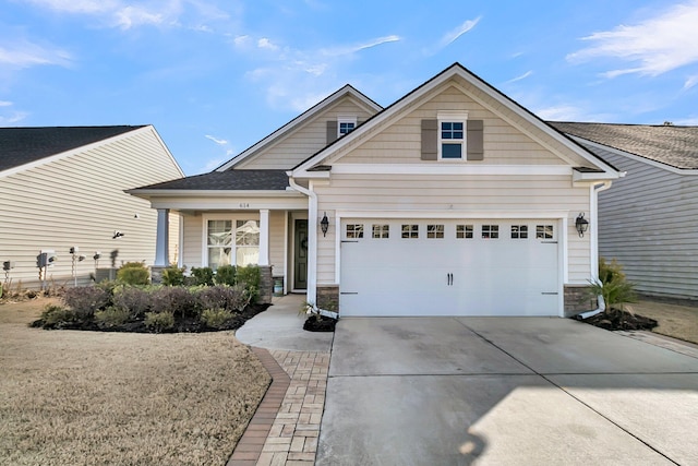 craftsman-style home featuring driveway and roof with shingles