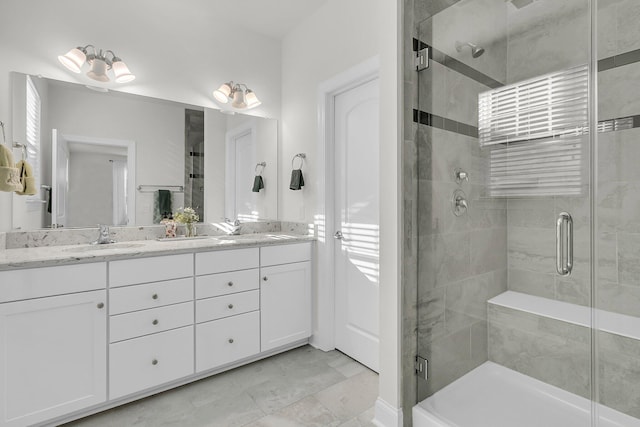 bathroom featuring double vanity, a sink, and a shower stall