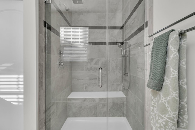 bathroom featuring visible vents and a stall shower