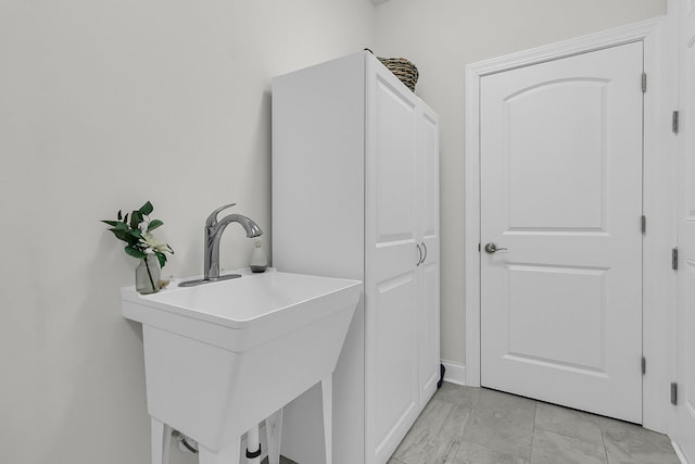 clothes washing area with a sink