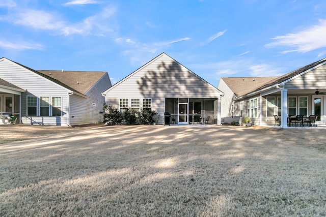 back of property with a ceiling fan, a sunroom, and a patio area