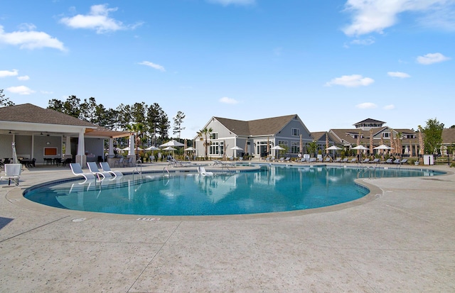 community pool featuring a residential view and a patio