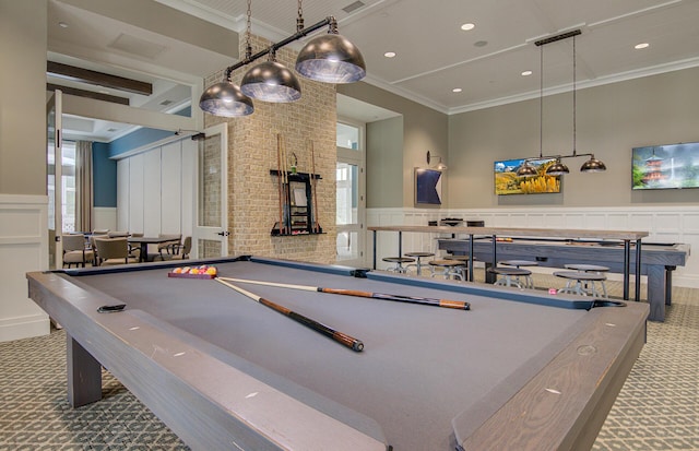 rec room with a wainscoted wall, carpet floors, ornamental molding, and billiards