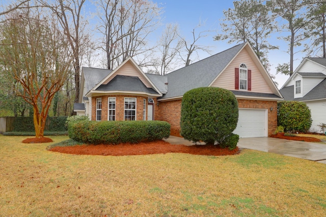 view of front of property featuring driveway, a shingled roof, a front yard, an attached garage, and brick siding