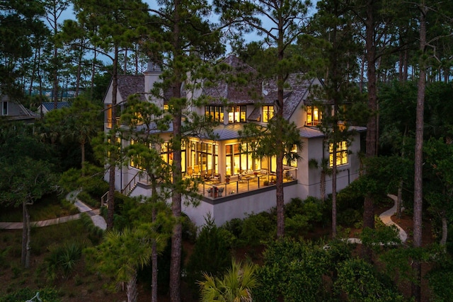 79 Trailing Vine Way, Kiawah Island, SC 29455 - back of house featuring a standing seam roof, stucco siding, a metal roof, and a sunroom