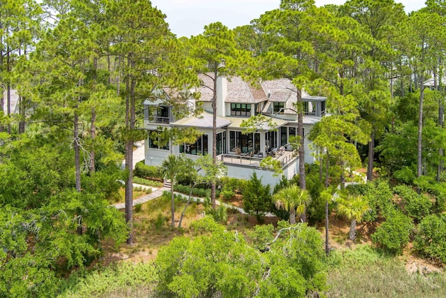 79 Trailing Vine Way, Kiawah Island, SC 29455 - back of property featuring a balcony, a standing seam roof, a metal roof, and view of wooded area