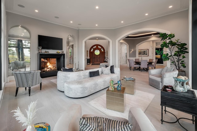 79 Trailing Vine Way, Kiawah Island, SC 29455 - living room with arched walkways, a multi sided fireplace, recessed lighting, crown molding, and light wood-style flooring