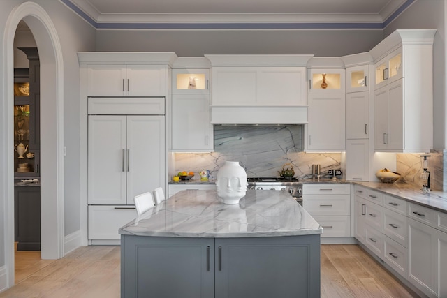 79 Trailing Vine Way, Kiawah Island, SC 29455 - kitchen featuring a center island, paneled built in fridge, ornamental molding, light wood finished floors, and tasteful backsplash