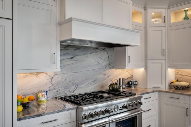 79 Trailing Vine Way, Kiawah Island, SC 29455 - kitchen featuring range with two ovens, custom range hood, tasteful backsplash, and white cabinetry