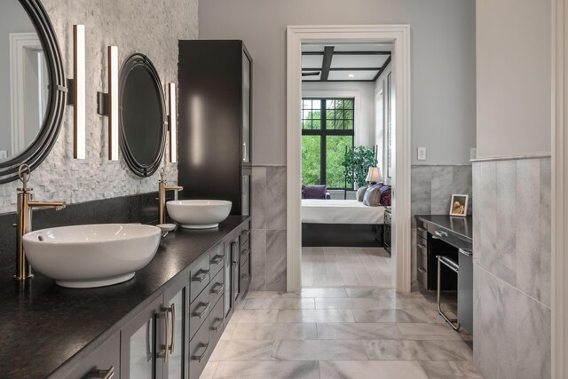 79 Trailing Vine Way, Kiawah Island, SC 29455 - ensuite bathroom with tile walls, a wainscoted wall, and double vanity