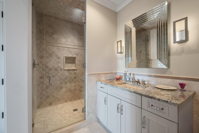79 Trailing Vine Way, Kiawah Island, SC 29455 - bathroom featuring vanity, tile walls, a stall shower, a wainscoted wall, and tile patterned flooring