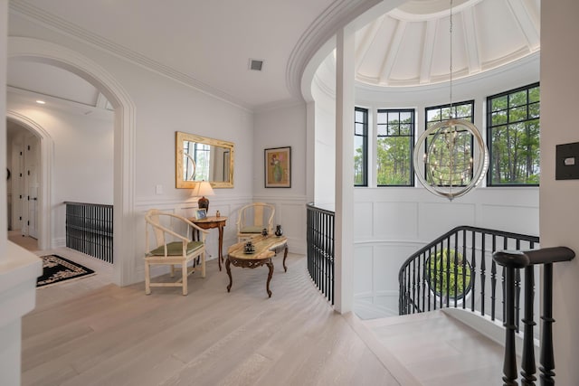 79 Trailing Vine Way, Kiawah Island, SC 29455 - corridor featuring a decorative wall, an upstairs landing, arched walkways, wood finished floors, and crown molding