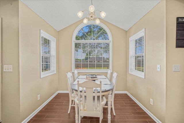 dining space featuring wood tiled floor, an inviting chandelier, vaulted ceiling, and baseboards