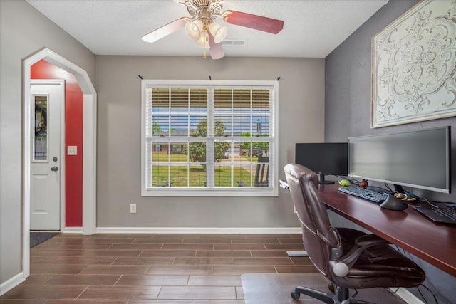 home office with baseboards, a ceiling fan, visible vents, and wood finish floors