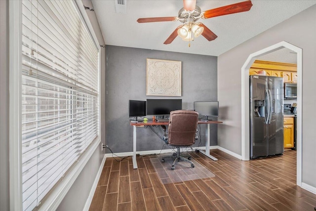 office with dark wood-type flooring, visible vents, and baseboards