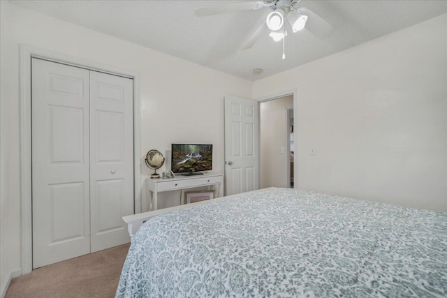 carpeted bedroom featuring a ceiling fan and a closet