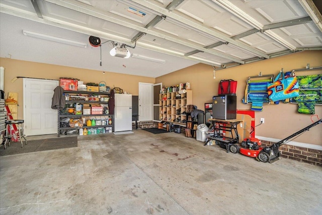 garage with a garage door opener and freestanding refrigerator
