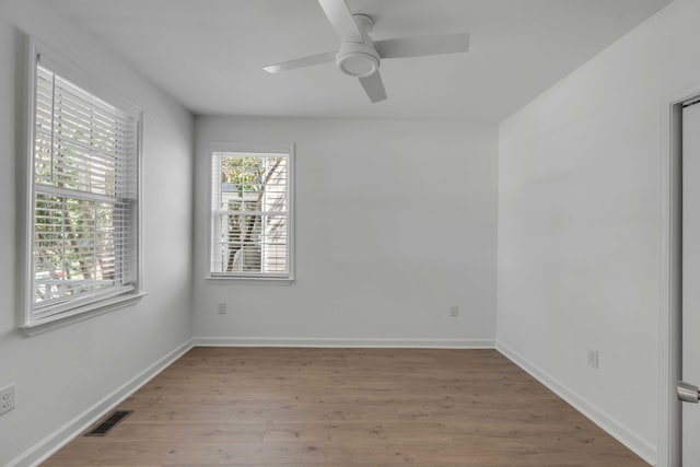 empty room featuring ceiling fan and light hardwood / wood-style flooring