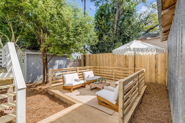 view of patio featuring a wooden deck, outdoor lounge area, and a shed