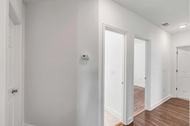 hallway featuring dark hardwood / wood-style flooring