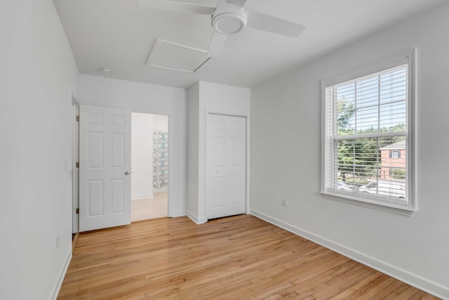 unfurnished bedroom with ceiling fan, light hardwood / wood-style floors, and a closet