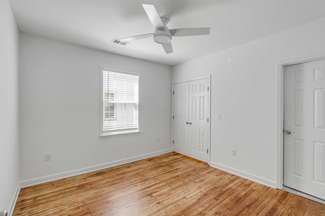 unfurnished bedroom with ceiling fan, light hardwood / wood-style floors, and a closet