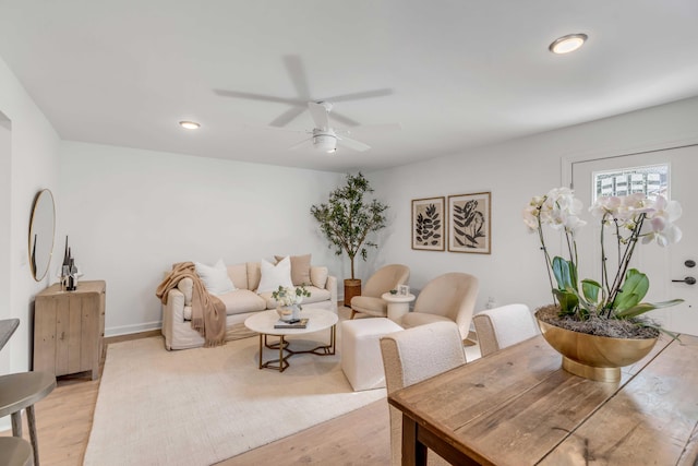 living room featuring ceiling fan and light wood-type flooring