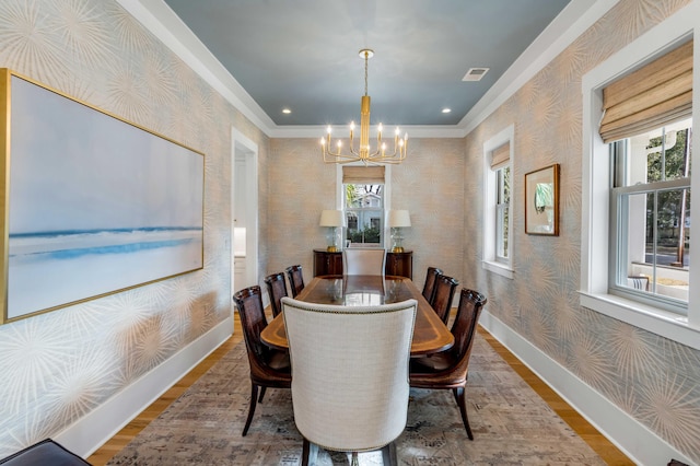 dining space with baseboards, wood finished floors, and wallpapered walls