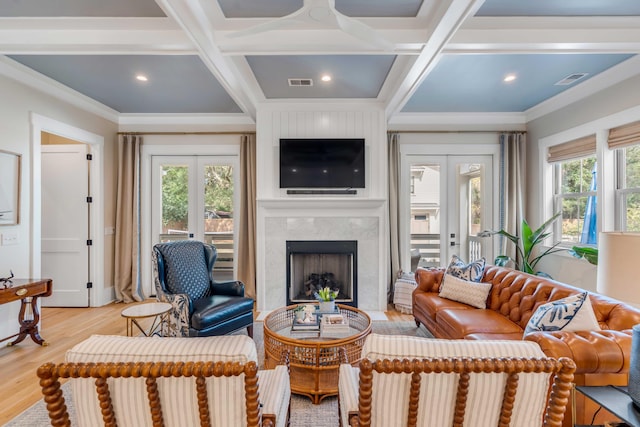 living room with french doors, coffered ceiling, visible vents, and light wood-style floors