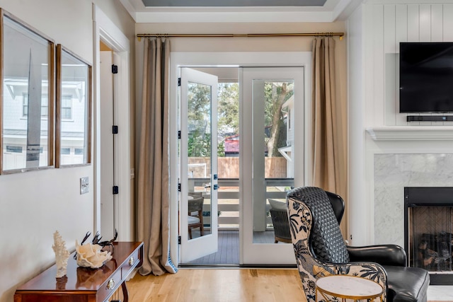 doorway with a fireplace and wood finished floors