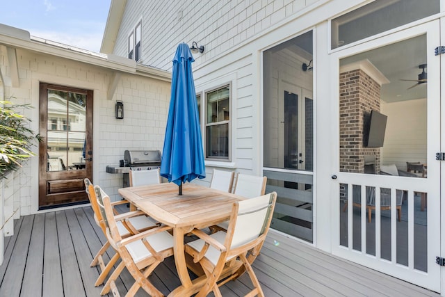 wooden deck with a grill and outdoor dining space