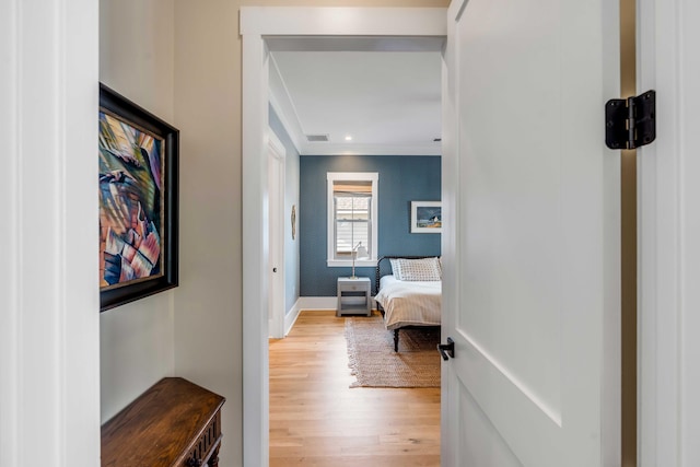 hall featuring light wood finished floors, recessed lighting, visible vents, baseboards, and wallpapered walls