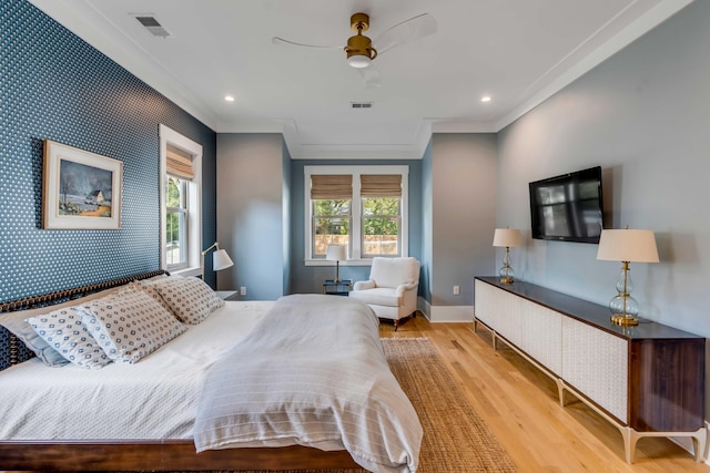 bedroom with wallpapered walls, visible vents, baseboards, light wood-style flooring, and an accent wall