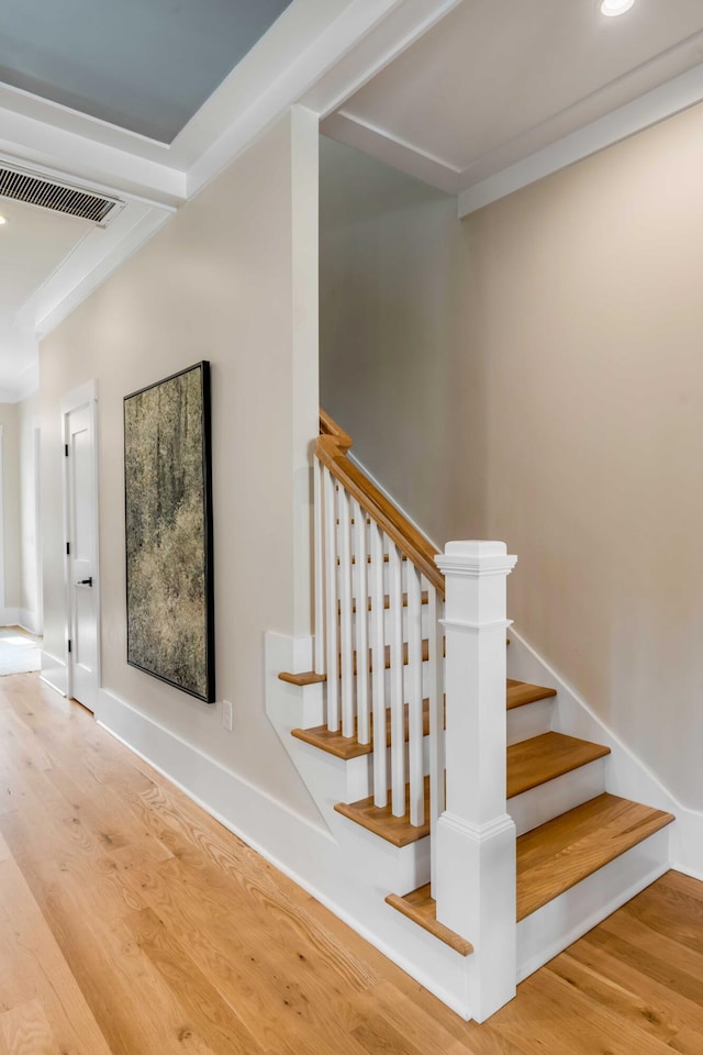 stairs featuring recessed lighting, visible vents, baseboards, and wood finished floors