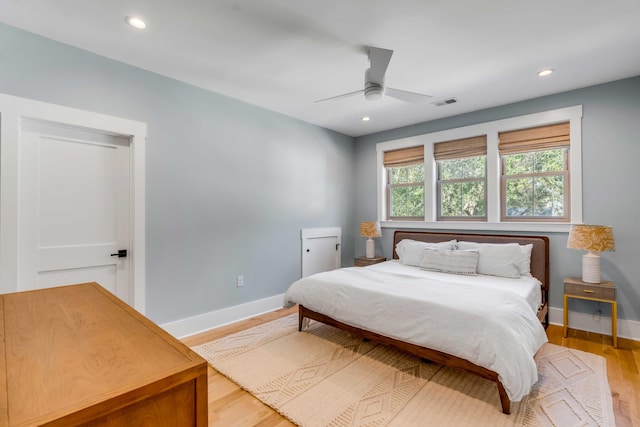 bedroom with light wood-style floors, recessed lighting, visible vents, and baseboards