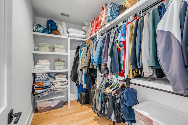 walk in closet featuring visible vents and wood finished floors