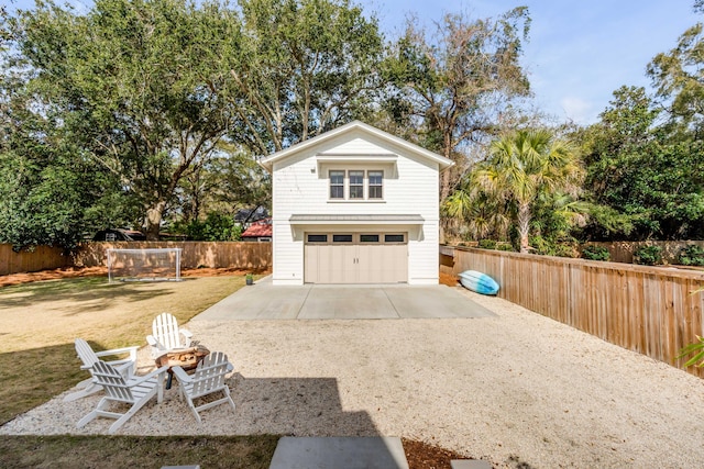 garage with driveway and fence