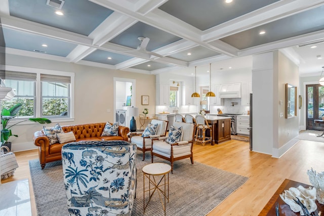 living room with light wood-type flooring, visible vents, coffered ceiling, and beamed ceiling